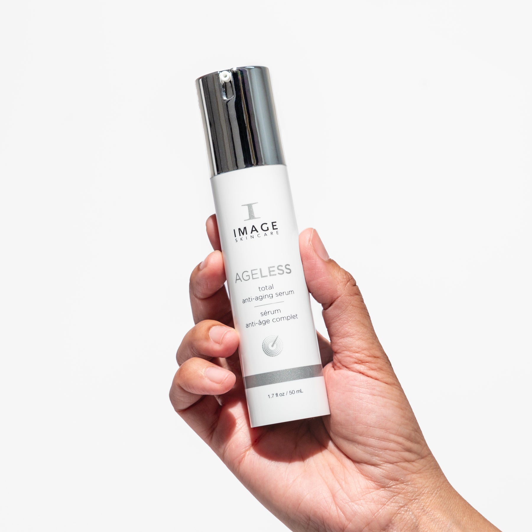 model hand holding serum bottle