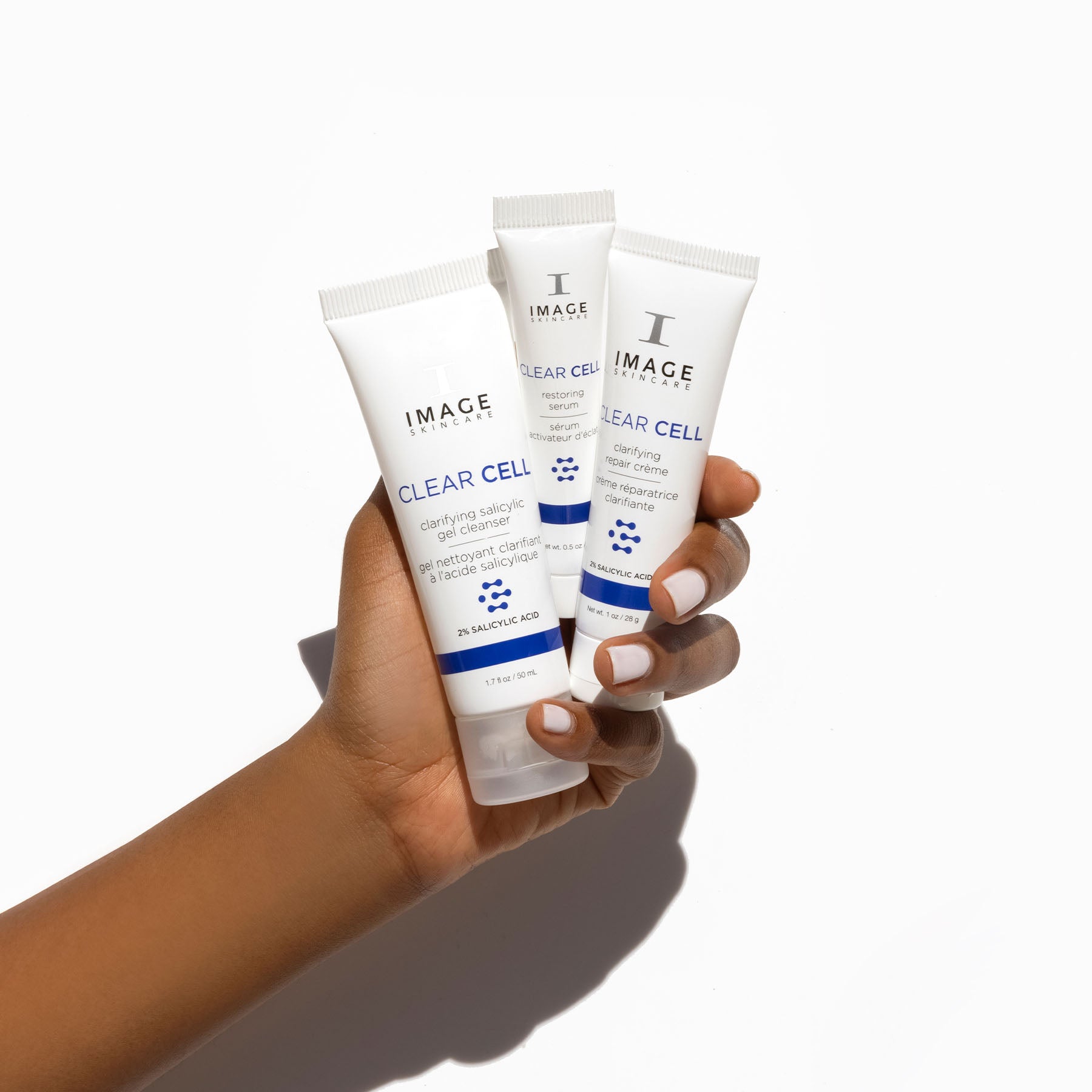 model hand holding all 3 travel size products
