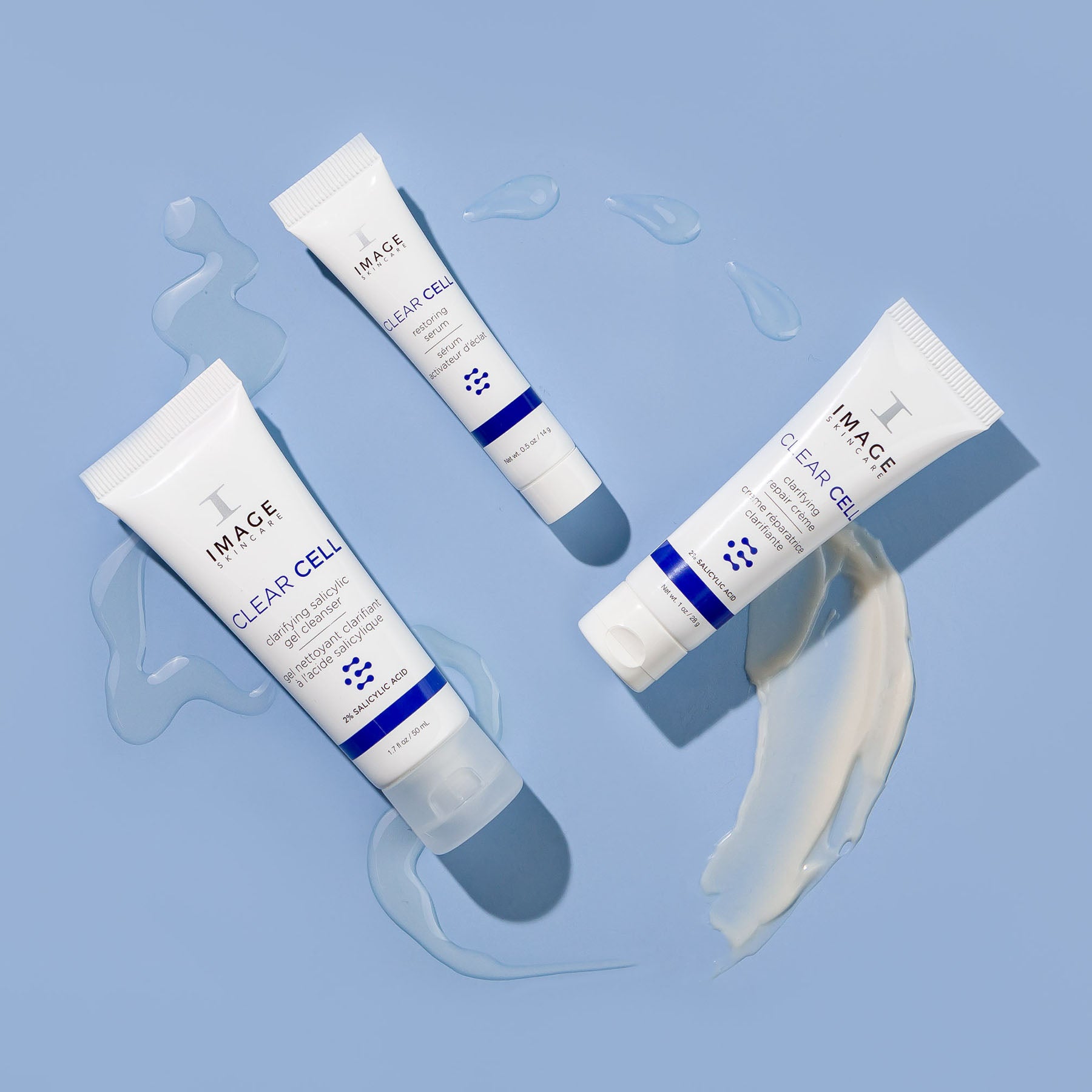 clear cell salicylic cleanser, restoring serum , and repair creme travel size products on blue background with product swatches below each product