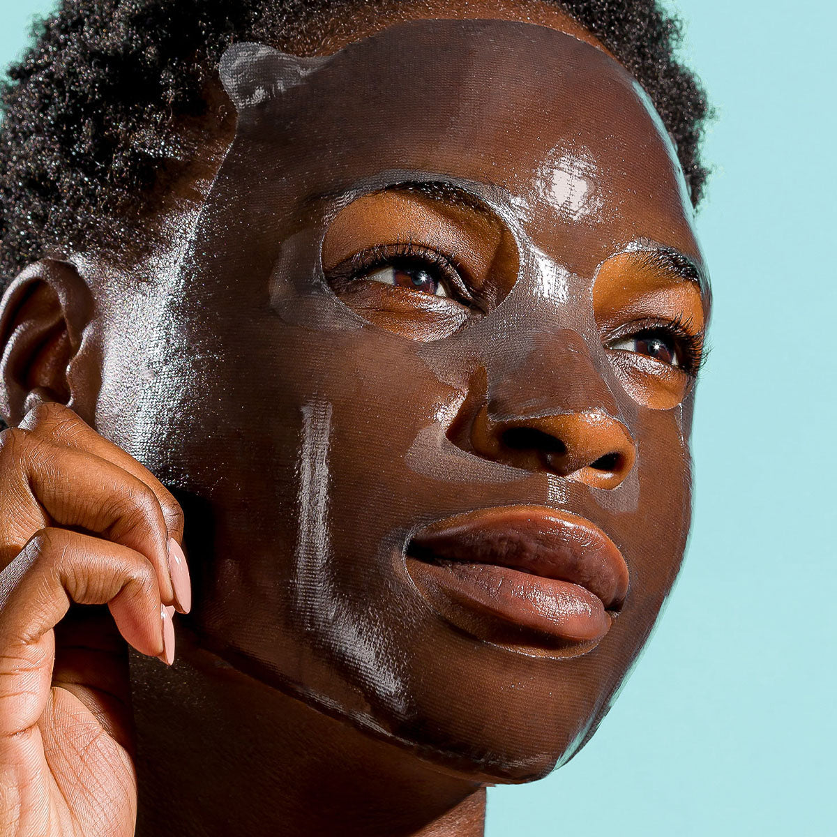 model with sheet mask on her face