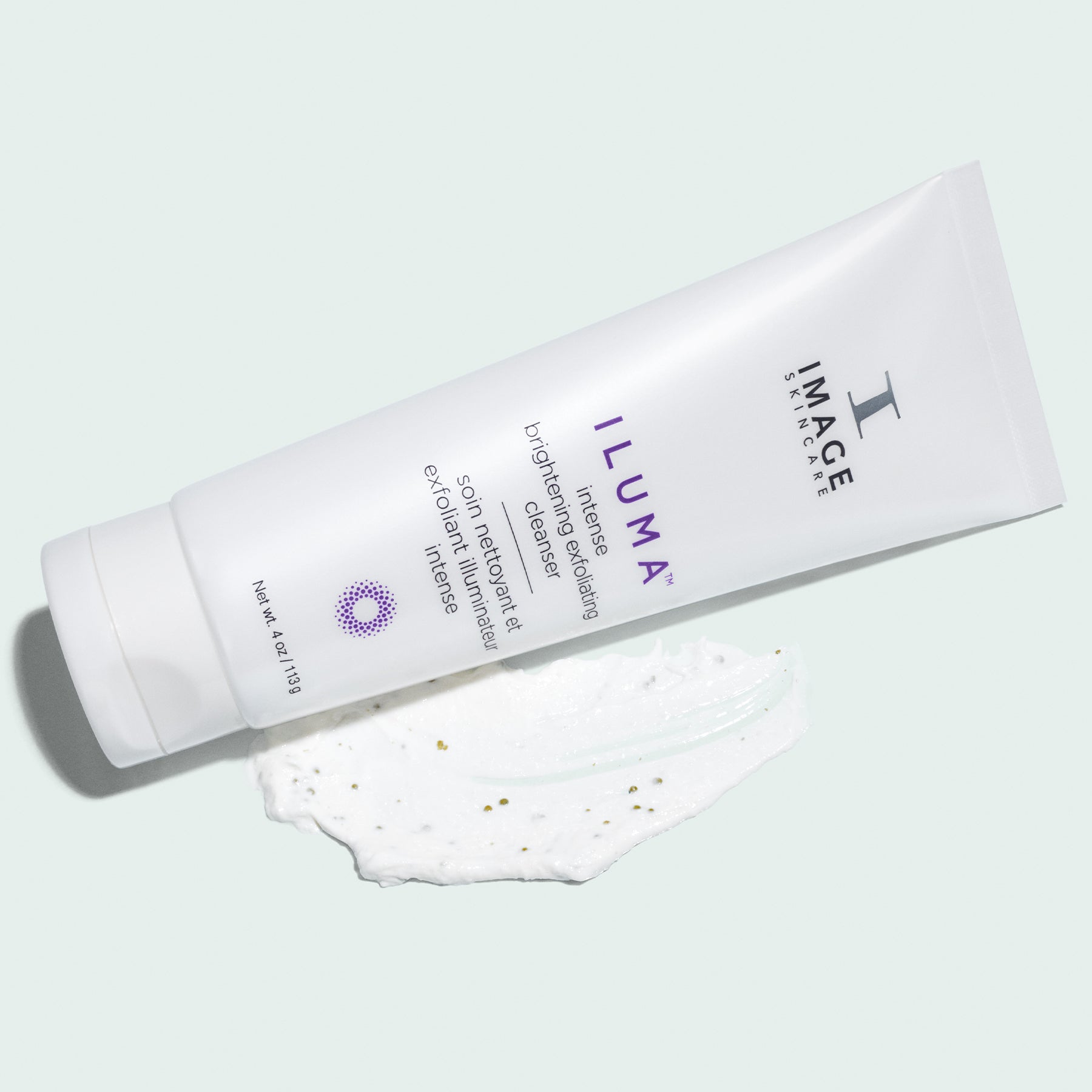 iluma cleanser retail size tube laying on product texture swatch